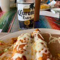 Enchiladas Suizas · Topped with a mild tomato sauce and melted cheese sour cream.