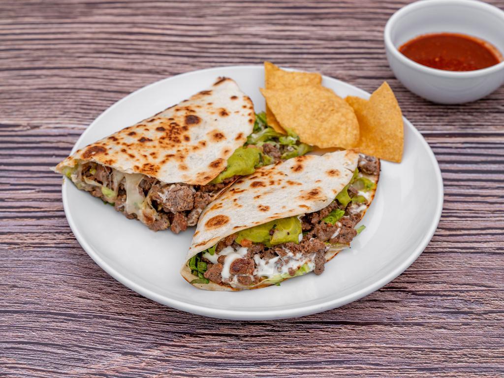 Quesadillas · Choice of meat, cheese, Lettuce, guacamole and sour cream.