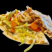 Sincronizada · Grilled quesadilla with pierna (marinated pulled pork) topped with lettuce, tomatoes, red on...