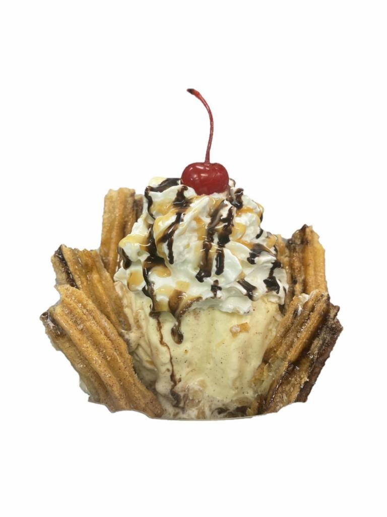 Hot Churro Sundae · Cinnamon sugar churros topped with your favorite ice cream and whipped cream and drizzled with chocolate and caramel sauce.
