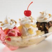 Banana Split · Sweet cream, chocolate, and strawberry ice cream with a banana on bottom. Served with pineap...