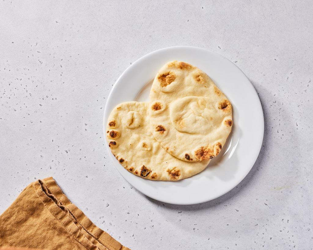 Naan (V) by dosa by DOSA · By dosa by DOSA. Indian flatbread, cooked tandoori style...the perfect companion to every curry, salad, and chutney! Contains gluten, dairy, and soy. We cannot make substitutions.