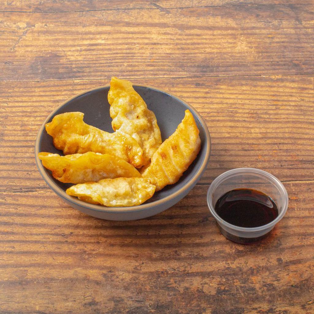 Pork Gyoza · Crispy dumplings filled with minced pork. Served with our gyoza dipping sauce. Contains gluten, soy, nightshades, and eggs. We cannot make substitutions.