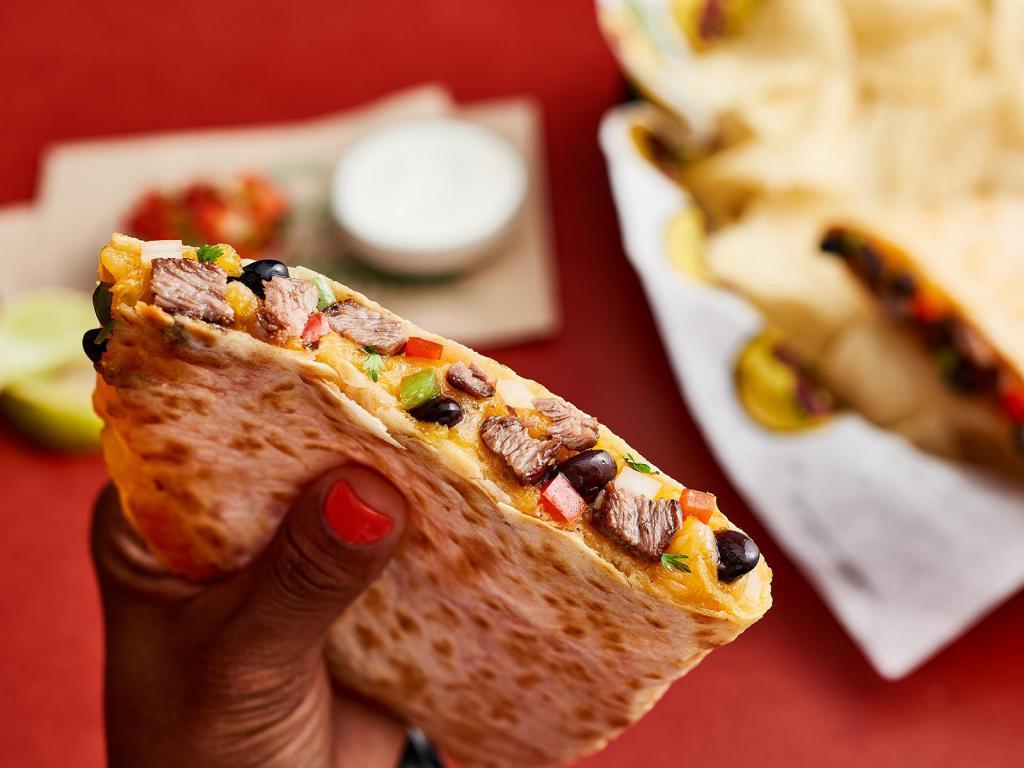 John Coctostan Quesadilla · Served in a flour tortilla with your choice of beans and shredded cheese with a side of pico de gallo and sour cream. Your protein options include all-natural steak, adobo chicken, ground beef or organic tofu.