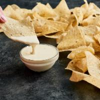 Moe's Famous Queso · Moe’s Famous Queso, the perfect partner with made in-house daily free chips or added to any ...
