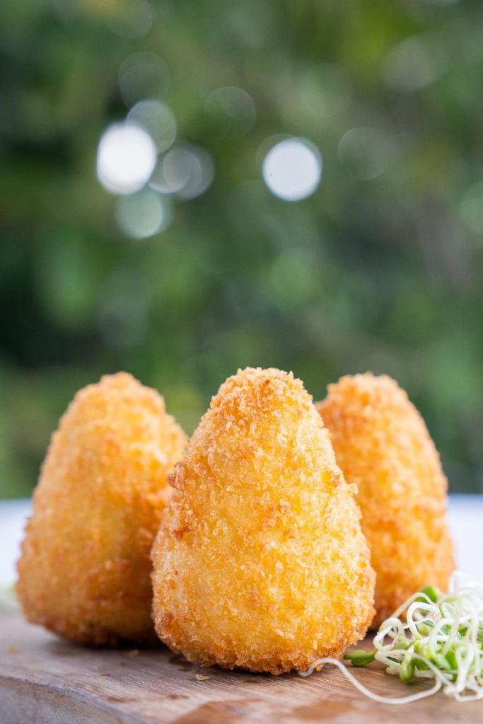 Coxinha · 5 pieces. Perfect bite-sized Brazilian fried croqueta filled with seasoned pulled chicken breast and real catupiry cheese.
