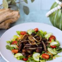 Steak Salad · Prime top sirloin cap (picanha 7oz.), sauteed red onions served on a mixed greens salad with...