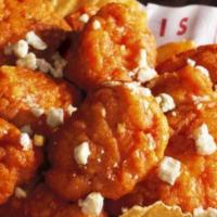 Boneless Wings · Tender and crunchy all-white chicken breast tossed in your choice of sauce: Buzz Sauce - Ban...
