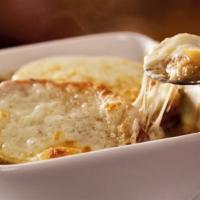 French Onion Soup · Say “oui” to this fresh favorite topped with melted Provolone and Parmesan.