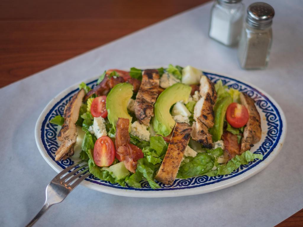 62. Cobb Salad · Romaine lettuce, tomato, cucumbers, Gorgonzola cheese, turkey bacon, avocado and grilled chicken with honey mustard dressing.