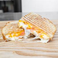Ultimate Grilled Cheese Sandwich · Cheddar, Swiss, provolone, tomato, sourdough griddle. Add bacon for an additional charge.