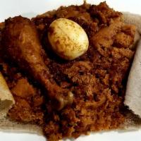 Doro Firfir · Spicy chicken sauce simmered with pieces of Injera served with traditional cottage cheese, b...