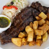 Bife de Churrasco · Flank Steak accompanied with Rice and Fried Potatoes with a side of Chimichurri Sauce