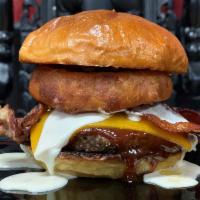 The IRON OUTLAW BBQ Bacon Cheeseburger ·  1/3lb beef patty, chipotle mayo, bacon, BBQ sauce, cheddar and onion ring, topped with our ...