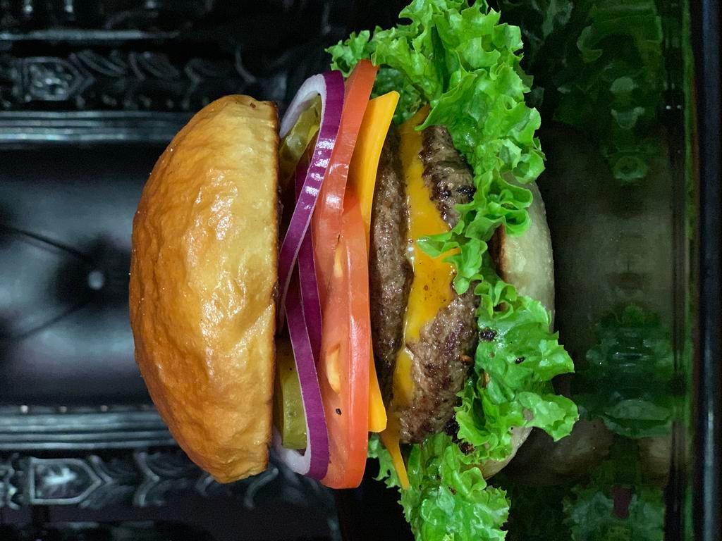 Heresy Burger · This burger rocks! Double meat, green leaf lettuce, tomato, red onion, pickles, served on a tall brioche bun. Comes with a side of our unique rosemary fries! 