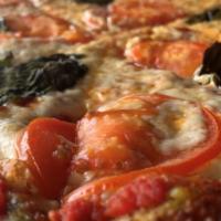 Tomato Basil Pizza  · Medium-thin crust with red wine marinara.  Garlic/Pesto/Basil brushed crust, covered with mo...