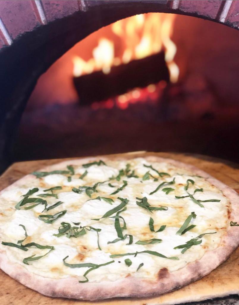 White Pizza · Garlic, ricotta cheese, mozzarella, basil, and herb Alfredo.