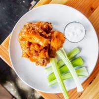 Buffalo Wings · Tossed with our house-made Buffalo sauce and served with celery, carrot sticks, and blue che...