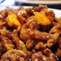 Orange Beef · Tender slices of beef sauteed with orange peels and hot pepper in a sweet hot sauce. Spicy.