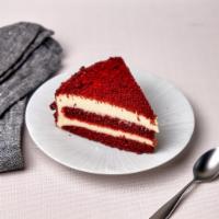 Red Velvet Cake Slice · Layers of vanilla and cocoa flavored red velvet sponge cake with vanilla cream cheese frosting
