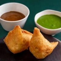 Samosas · Flaky puff pastry filled with spiced potatoes and peas, with tamarind and cilantro chutneys ...