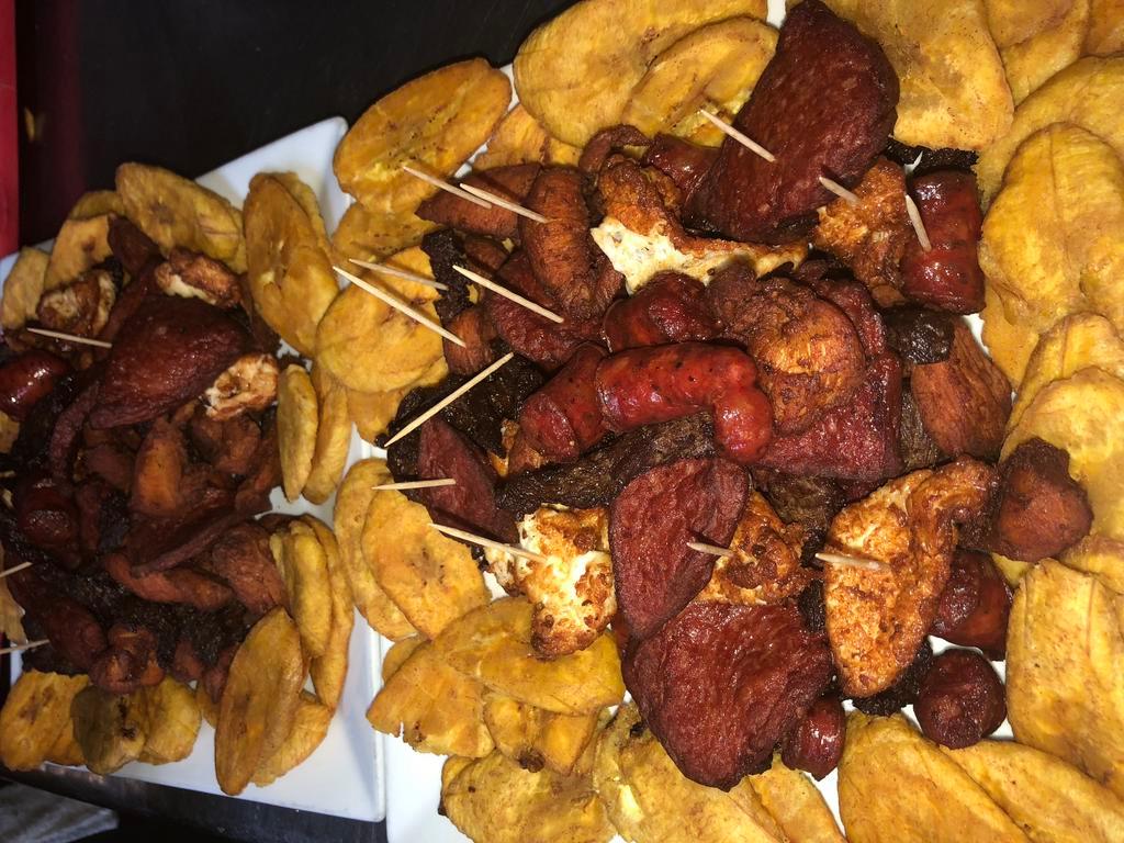 Picadera Pequeña · Tray of pork, beef, boneless chicken chunks, chicken with bone, cheese, salami, dominican sausage, fried green plantains.