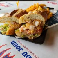 Fried Shrimp Po' boy · Served with choice of French fries, sweet potato fries or Cajun fries and also with lettuce,...