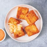 Classic Mac Bites · 4 Golden-fried mac & cheese bites served with house sauce for dunking