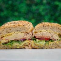 Tuna Melody Sandwich ·  Pretzel bun/ multigrain sourdough bread with House Tuna, tomato, red onion, lettuce and hon...