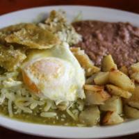 Chilaquiles · Fried tortilla Chips Sautéed in Hot sauce topped with Queso Fresco, Onions, Fried Egg, Lettu...