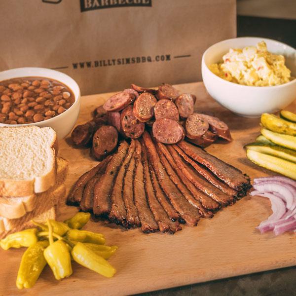Gameday Pack · Serves 3-4. 1 1/2 pound of our tasty smoked meat, 2 sides (1 pint each), and 4 slices of Texas toast. Includes pickles, peppers, onions and BBQ sauce.
