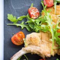 Costoletta di Vitello alla Milanese · 
Pan Fried Pounded and Breaded  Veal Chop Milanese Served w/ Arugula, Cherry Tomato Salad an...