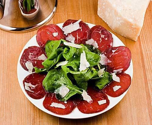 Bresaola della Valtellina, Arugula e Parmigiano · Thin sliced imported cured bresaola, arugula, shaved, parmigiano cheese, lemon evoo