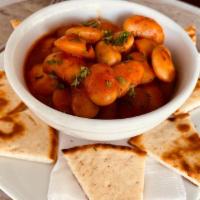 Gigandes Large · Jumbo lima beans baked in a red sauce and served with pita