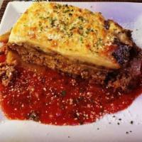 Moussaka · Layers of sliced potatoes, zucchini and seasoned chopped meat topped with a creamy bechamel ...