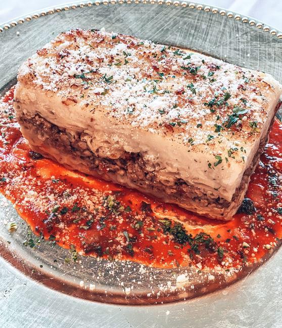 Pastitsio · A Greek version of lasagna. Greek-style ziti pasta, seasoned chopped meat and a creamy bechamel sauce.