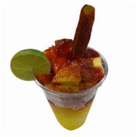 Raspados Locos · A snow cone topped with fruit, tamarindo, chamoy, limin, & tajin, gummys