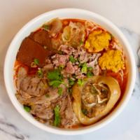 Bun Bo Hue Vermicelli · Lemongrass beef noodle soup served with sliced beef and Vietnamese ham. Flavorful broth cont...