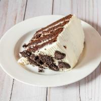 Oreo Cake Slice · Moist chocolate cake layered with our cream cheese icing. Also, layered and topped with Oreo...