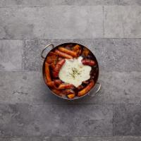 Jjajjang Tteokbbokki · Served with rice cake, fish cake, sausage, mozzarella cheese, onion and cabbage in special b...