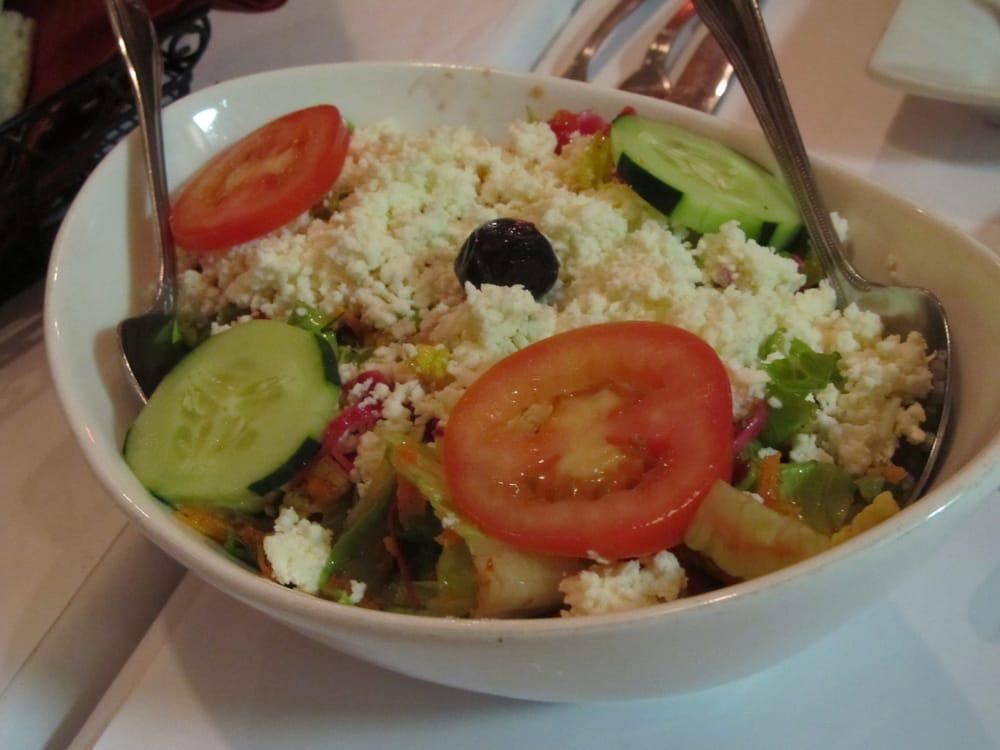 Mediterranean Salad · Akdeniz salatasi. Fresh romaine lettuce, shredded carrots and topped with tomatoes, cucumbers, feta and black olives. Served with lemon juice and olive oil dressing.