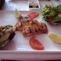 Grilled Salmon · Char-grilled filet of salmon and served with sauteed spinach, seasonal salad and oven baked ...