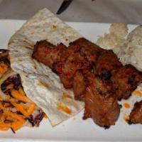 Shish Kebab · Marinated cubes of baby lamb grilled to delight on skewers. Served with rice, grilled pepper...