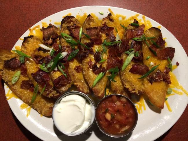 Loaded Tater Skins · Potato skins topped with melted cheddar cheese, bacon bits, green onions, and sour cream.