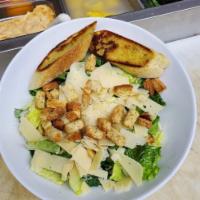 Classic Caesar Salad · Crisp romaine tossed with shredded parmesan-Reggiano, Caesar dressing, croutons, and served ...