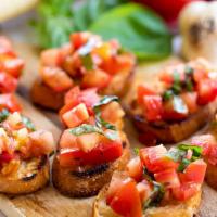 Bruschetta · Chopped fresh tomatoes with garlic, basil, olive oil, and vinegar, served on toasted slices ...