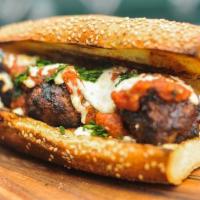Meatball Parmigiana Sandwich · Perfectly seasoned meatballs served on a toasted roll with lots of sauce and cheese.
