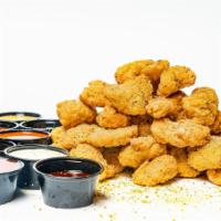 32 Bites · 32 pieces of oven-baked crispy chicken bites seasoned with your choice of dust and served wi...