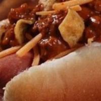 Frito Pie Dog · All beef hot dog covered in chili, cheese, chopped onions and Frito corn chips.