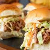 Barbecued Pulled Pork Sliders · Three Hawaiian rolls topped with barbecued pulled pork and creamy coleslaw with onion and pi...